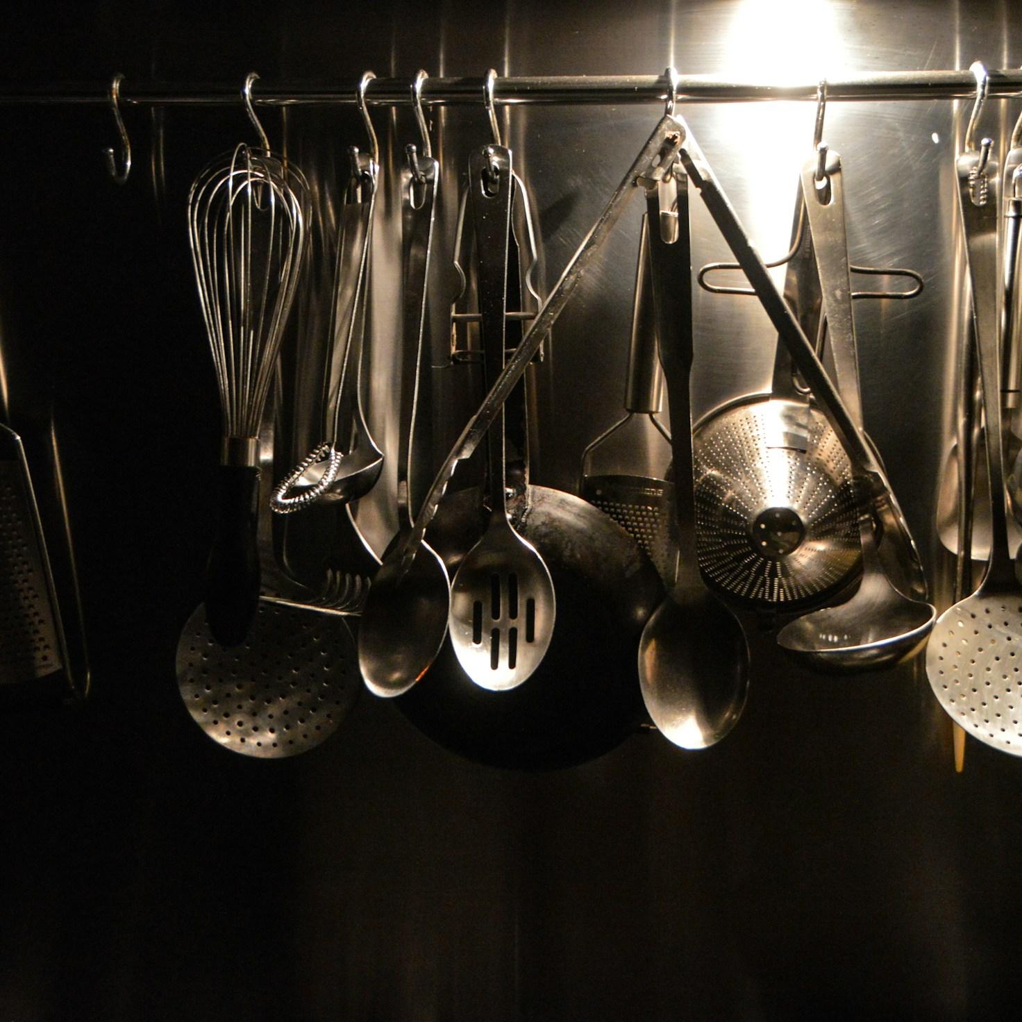 Community members cooking together in a modern kitchen space, sharing recipes and techniques